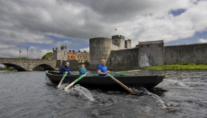 People rowing in front of King John's Castle